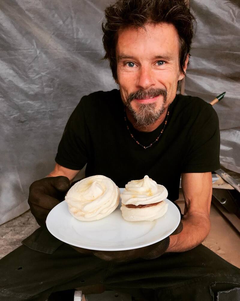 Man in workshop with meringue cakes
