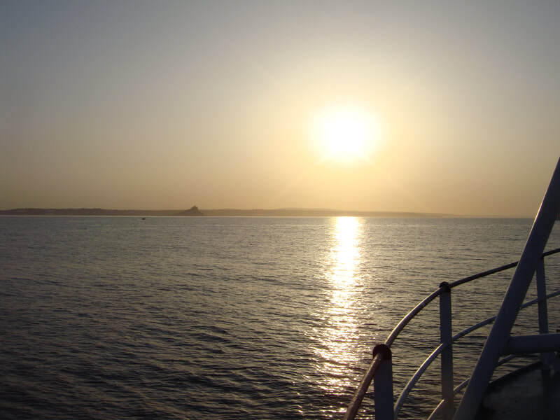 St Michael’s Mount in Cornwall at sunrise as viewed from a boat