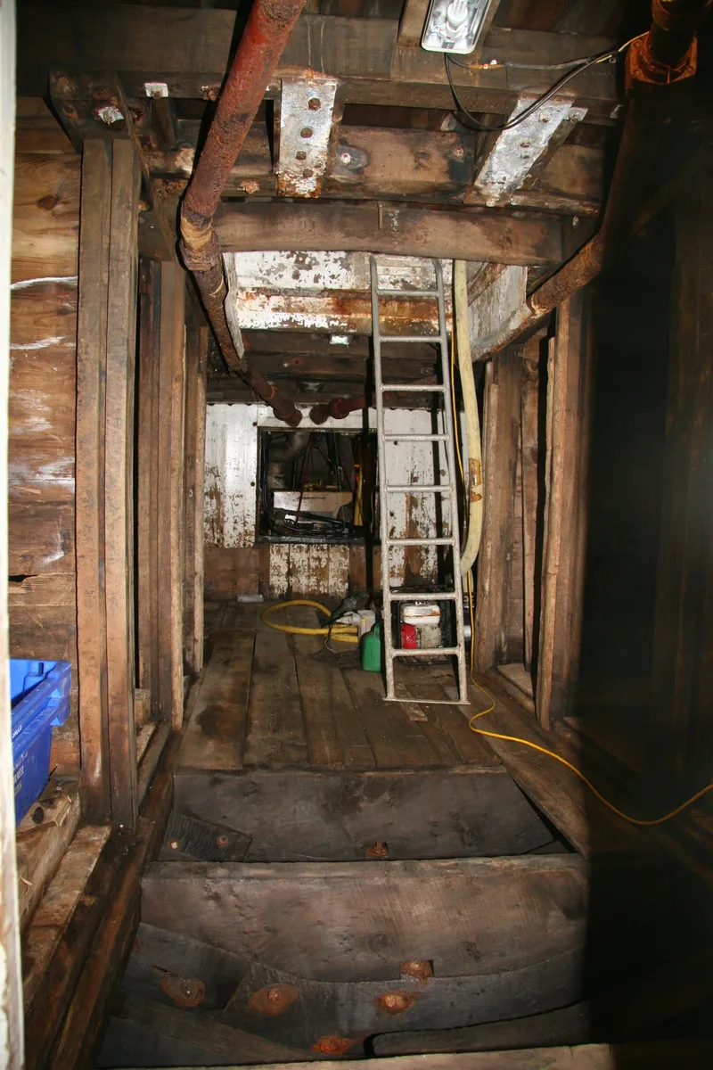 Inside the fish hold of a wooden fishing trawler