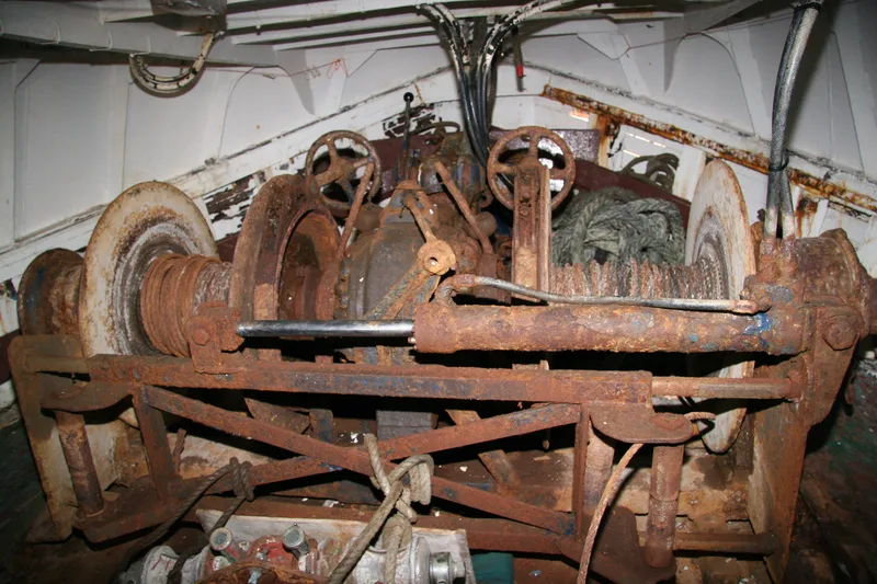 Large winch on board a wooden fishing trawler