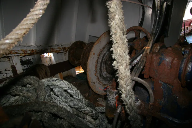 Winch and ropes on board a wooden fishing trawler