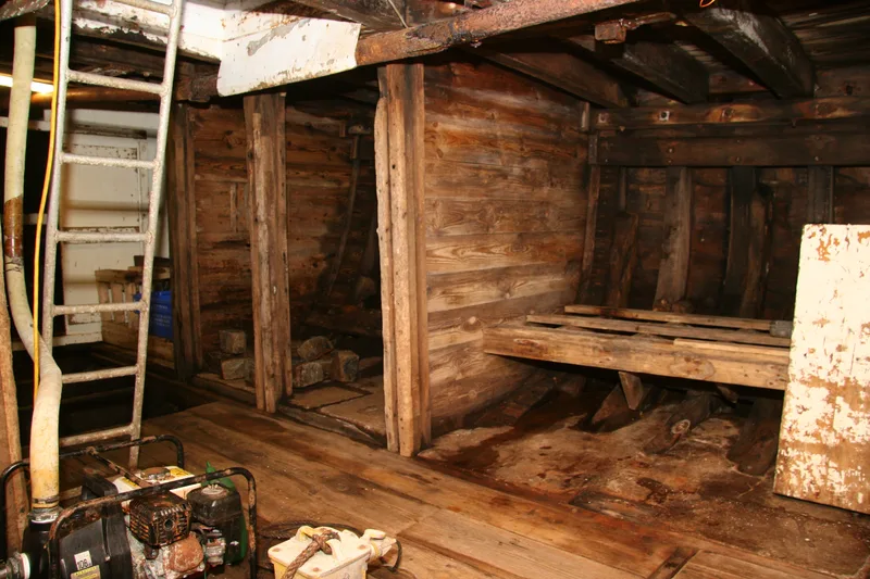 Inside the fish hold of a wooden fishing trawler